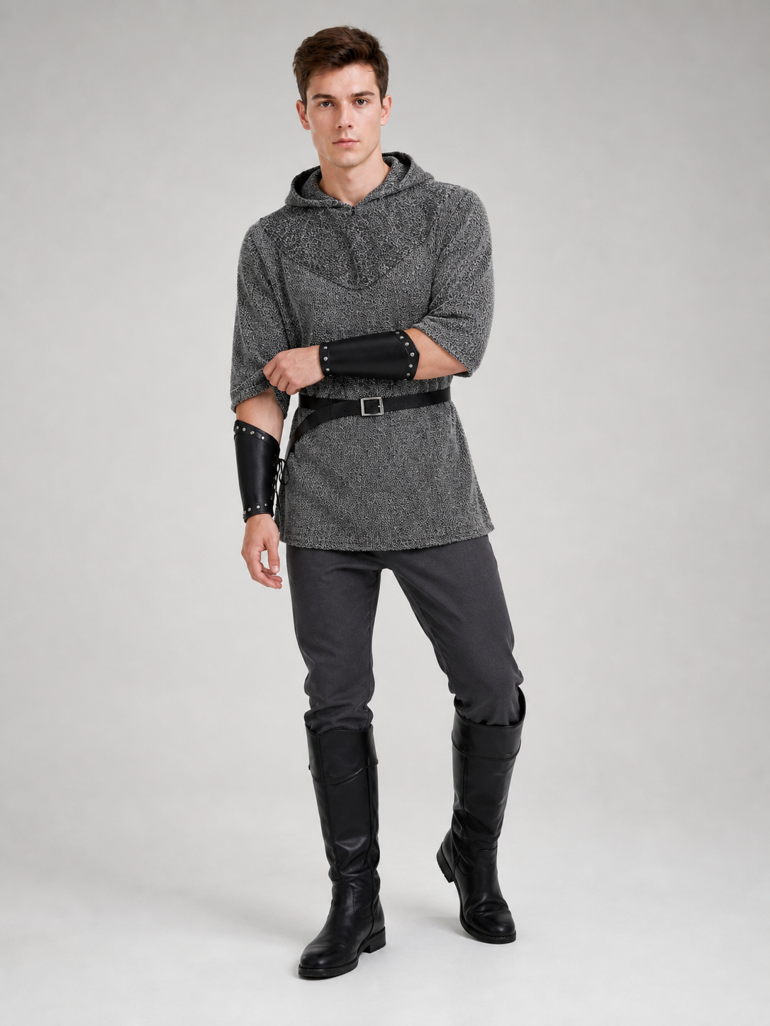 The costume is designed in the style of a medieval knight and is suitable for cosplay and stage performances. The set includes a gray hooded top with a layered front design, black pants, a belt, bracers, and greaves. The gray-and-black colo