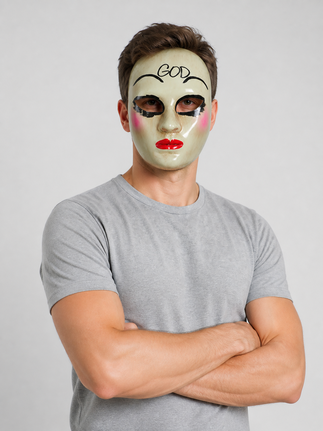 White glossy face mask shown on a model from the waist up, with painted black brows, outlined eyes, pink cheeks, and red lips