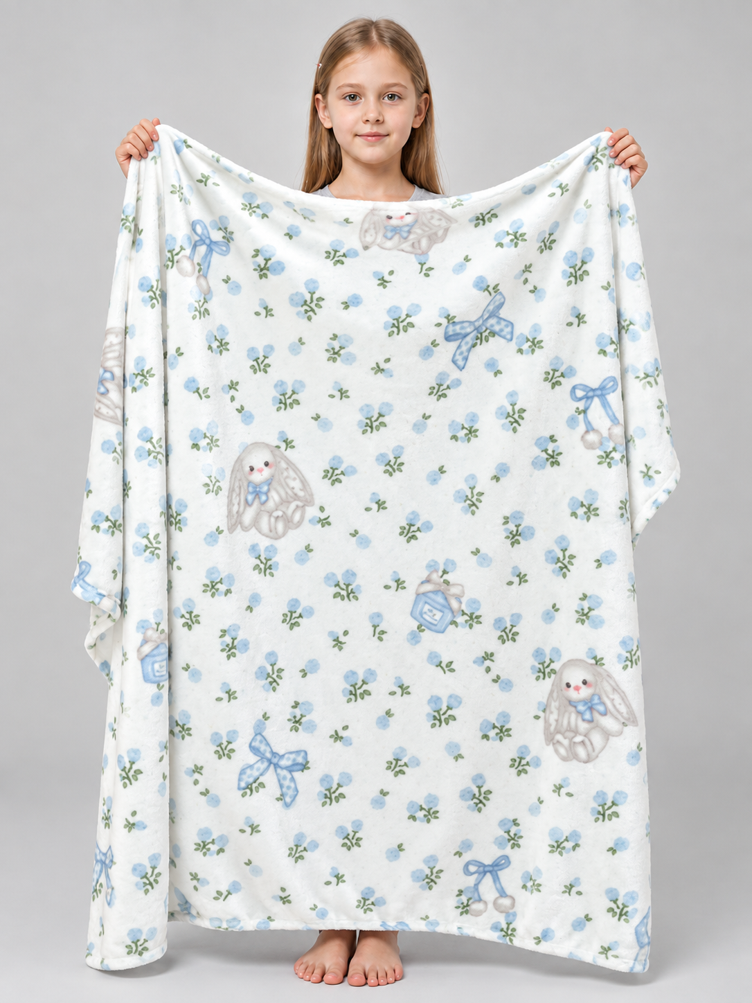 Reversible white blanket with a rabbit and bow pattern