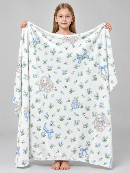 Reversible white blanket with a rabbit and bow pattern
