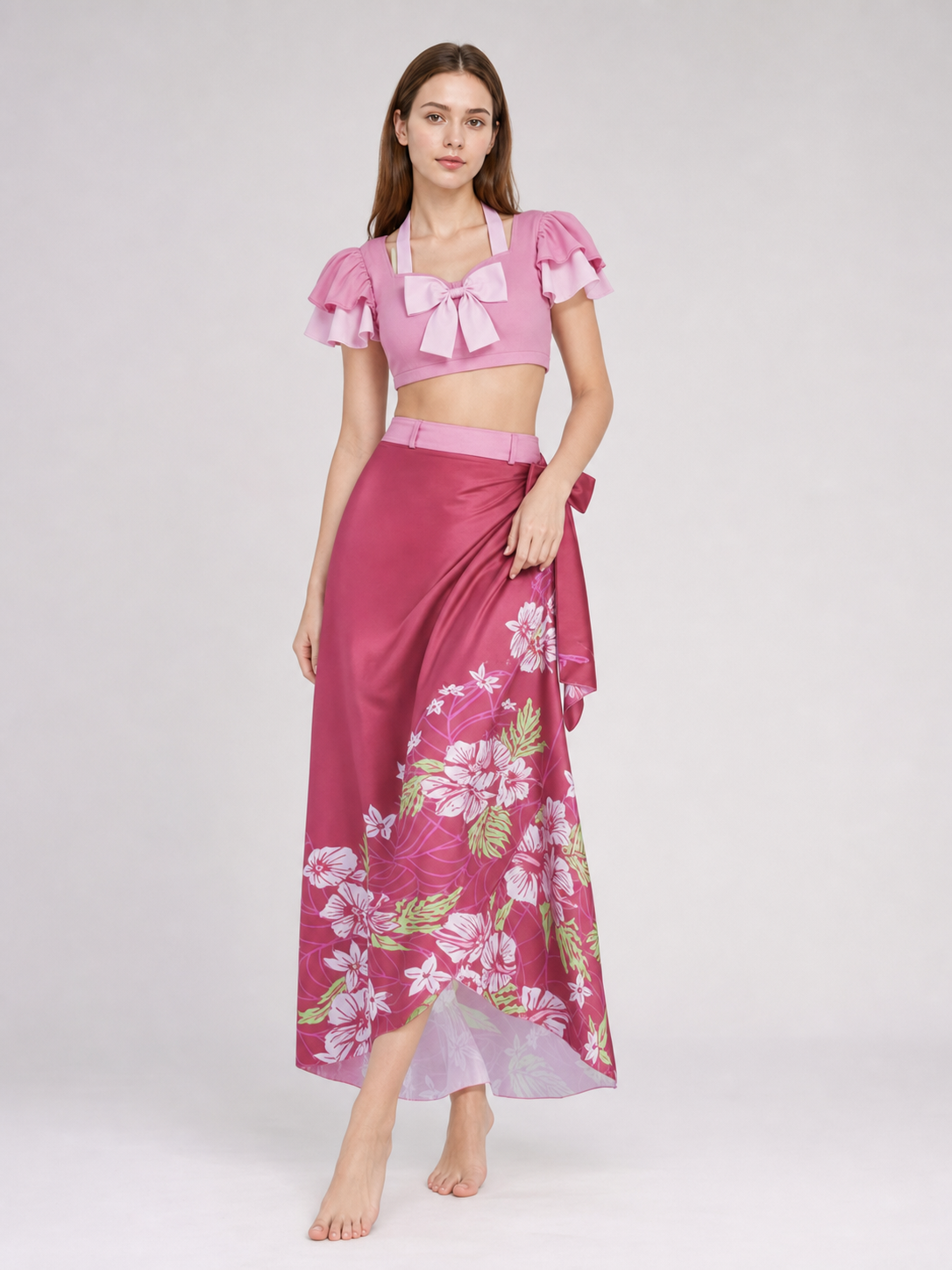 This cosplay set is designed as a short-sleeve crop top and a long skirt. It includes a top, a half-skirt, and decorative bows. There is a bow on the chest of the top, and another bow is placed on the side of the skirt waist. The top has an