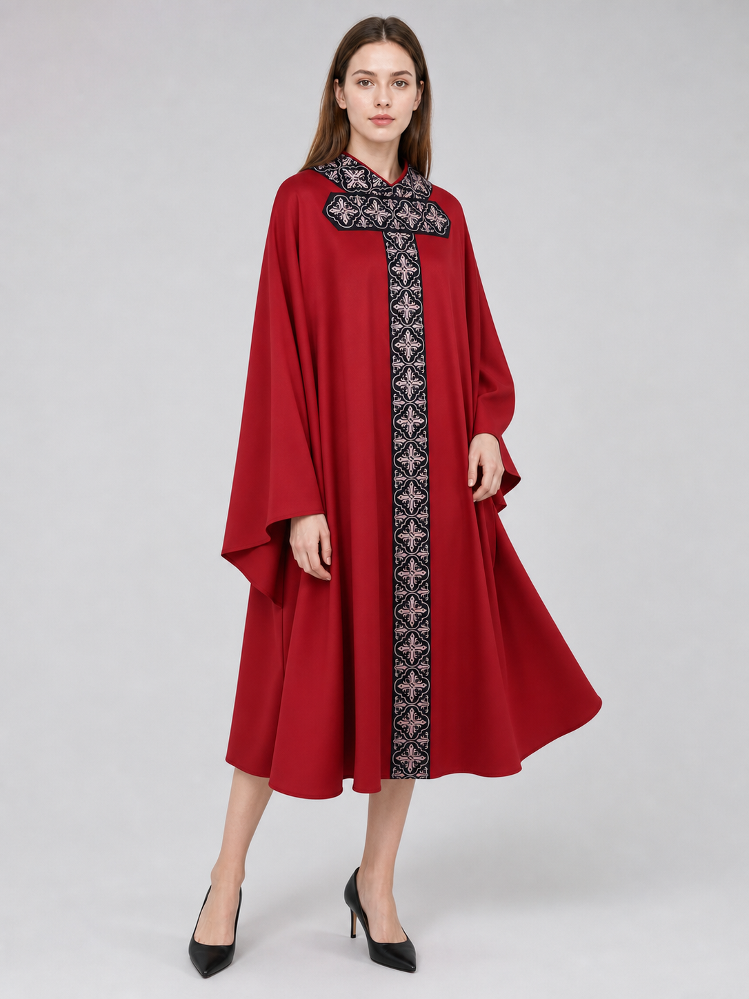 The cape is red with black decorative elements. It has a loose cloak-style silhouette, wide sleeves, and a collar with black patterned detailing. The front features a vertical decorative stripe down the center and a horizontal stripe across