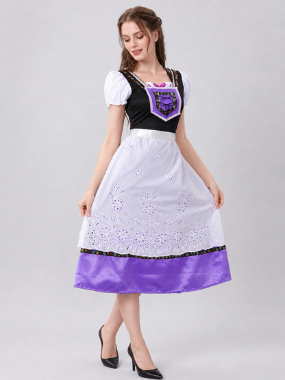 The dress is designed in an ethnic style and features a contrasting combination of white, pink, purple, and black. It has a black bodice, voluminous white puff sleeves, and a white waistband. The front is decorated with a purple lace-up det