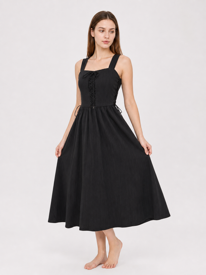 Black midi dress shown from the front at an angle, with a lace-up bodice, wide straps, side ties, and the skirt held slightly outward