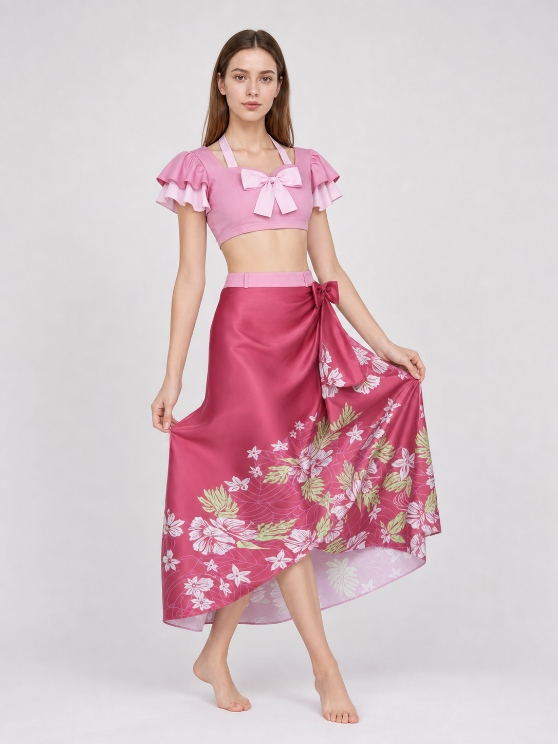 This cosplay set is designed as a short-sleeve crop top and a long skirt. It includes a top, a half-skirt, and decorative bows. There is a bow on the chest of the top, and another bow is placed on the side of the skirt waist. The top has an
