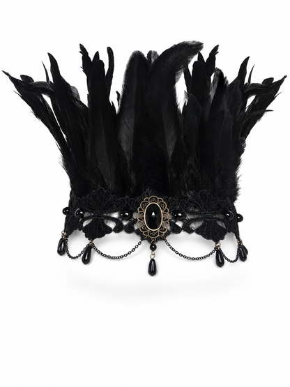Black feather headpiece with lace band, oval centerpiece, and dangling chains worn front-facing by a model in a gray T-shirt