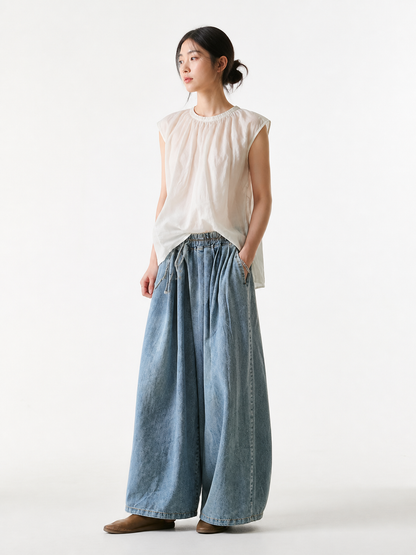 Casual culotte jeans in a light blue denim wash with a relaxed silhouette and cropped mid-calf length. The style features wide legs, classic denim stitching, and a noticeable faded texture. An elastic waistband and visible drawstring comple