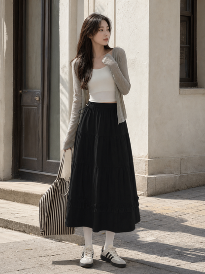 Long black A-line skirt with tiered pleats
