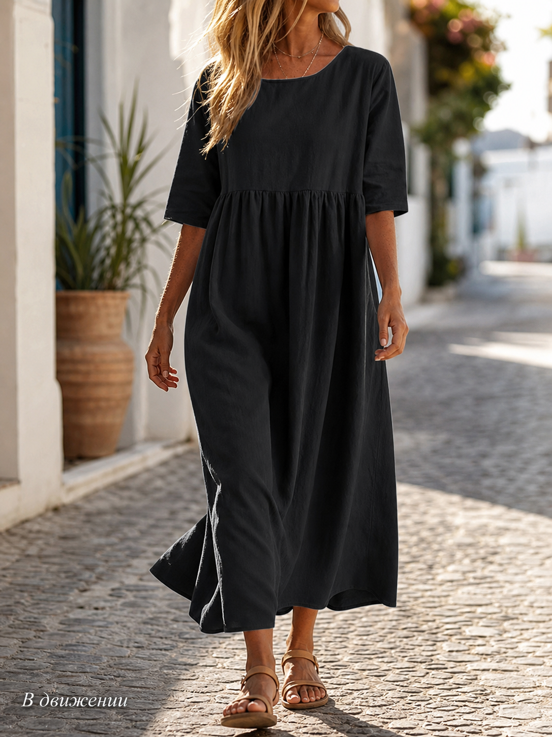 This black long dress features a round neckline, elbow-length sleeves, and a relaxed A-line silhouette. The solid-color design gives it a clean look and makes it easy to pair with different everyday wardrobe pieces. The top has a round neck