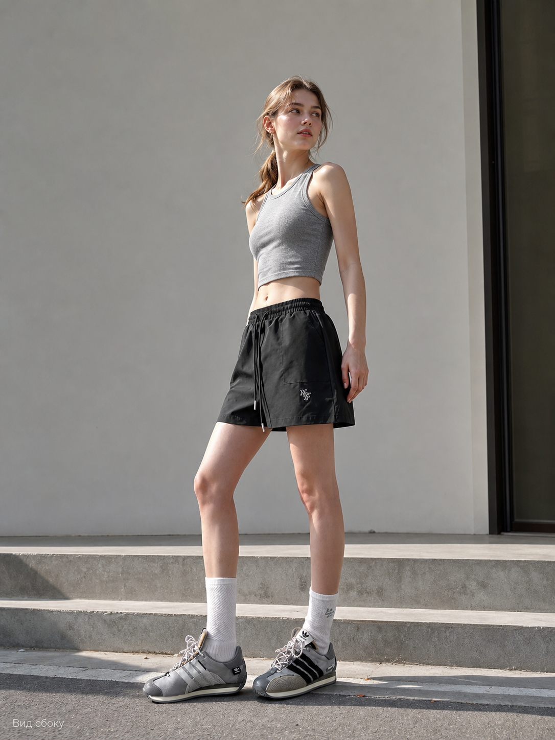 Loose-fit women's shorts with an elastic waistband and drawstring. The design features a minimalist style and a noticeable detail at the front—a drawstring for adjustment. The elastic waistband helps maintain a neat fit, while the loose cut