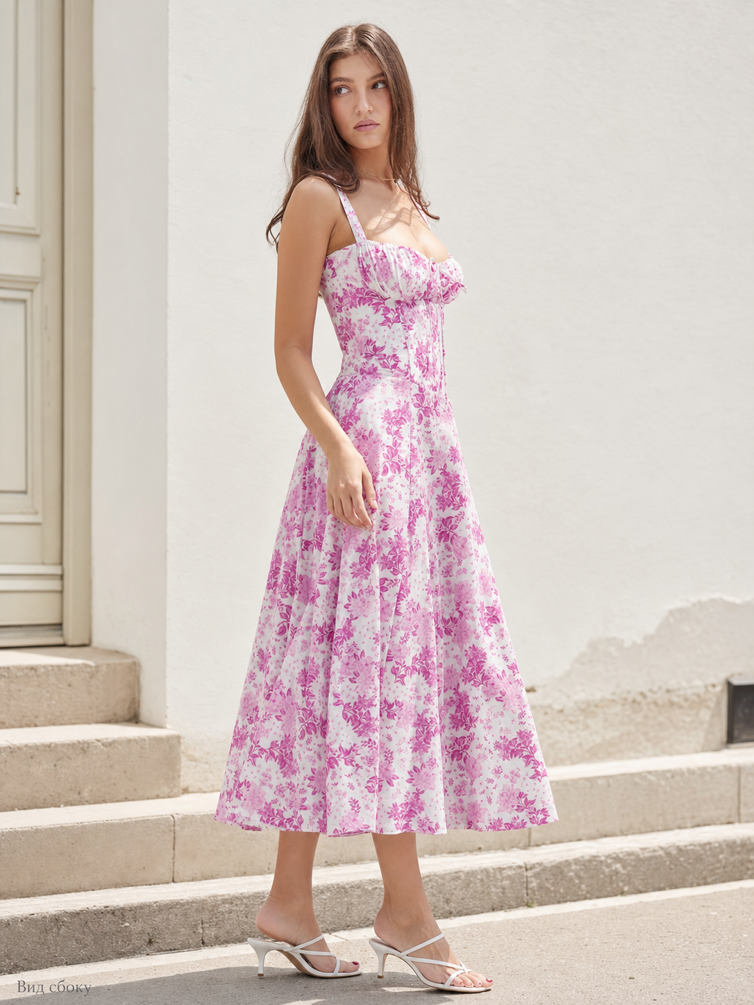 The design features a midi dress with thin straps and a square neckline. The