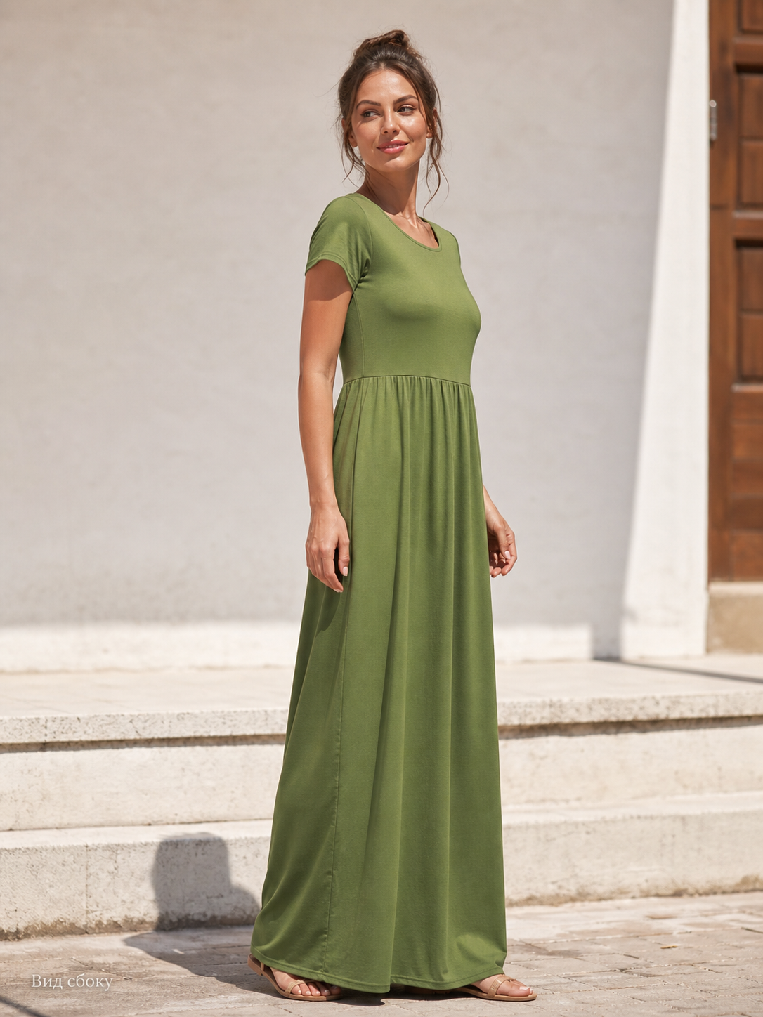 Everyday women's dress with a round neckline, short sleeves, and a long skirt. The dress is olive, or army green, in color. The top has a round neckline and short sleeves, while the waist features gathers that connect the bodice to the long