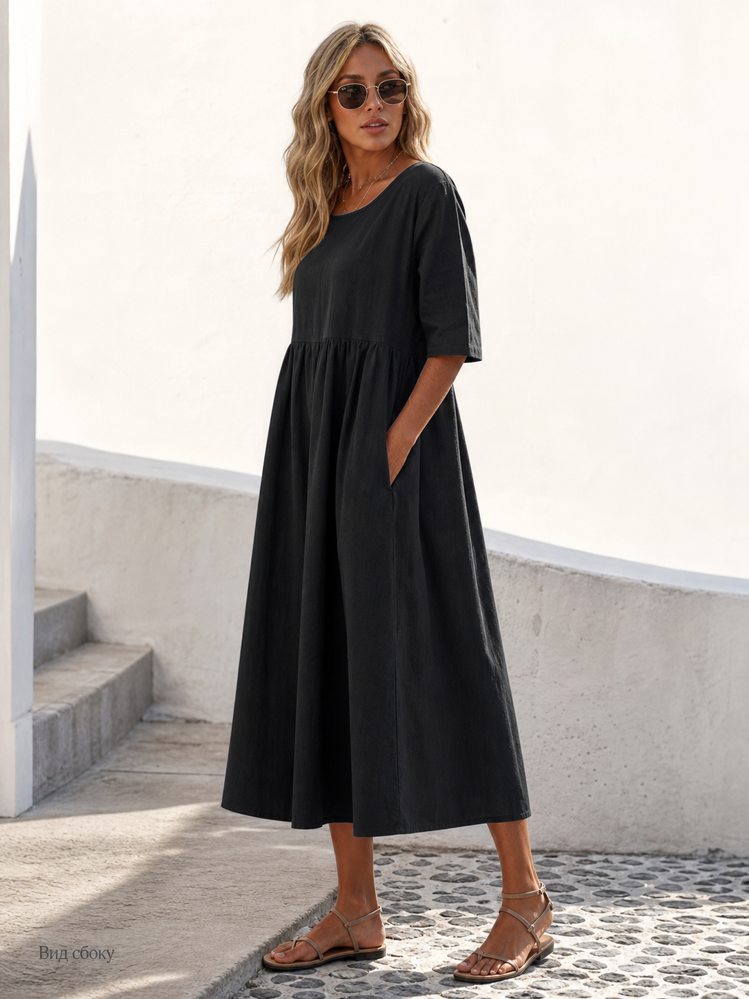 This black long dress features a round neckline, elbow-length sleeves, and a relaxed A-line silhouette. The solid-color design gives it a clean look and makes it easy to pair with different everyday wardrobe pieces. The top has a round neck