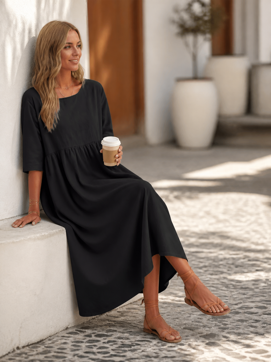 This black long dress features a round neckline, elbow-length sleeves, and a