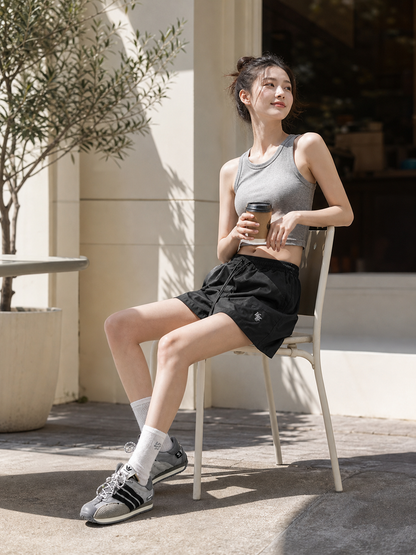 Loose-fit women's shorts with an elastic waistband and drawstring. The design features a minimalist style and a noticeable detail at the front—a drawstring for adjustment. The elastic waistband helps maintain a neat fit, while the loose cut
