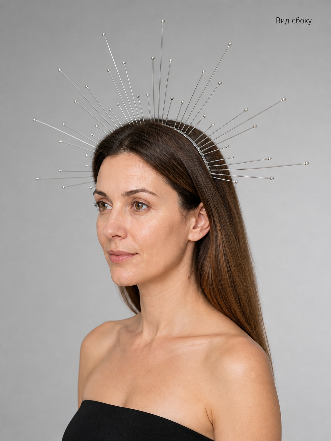 Silver halo headpiece with radiating bead-tipped wires worn by a model, side view