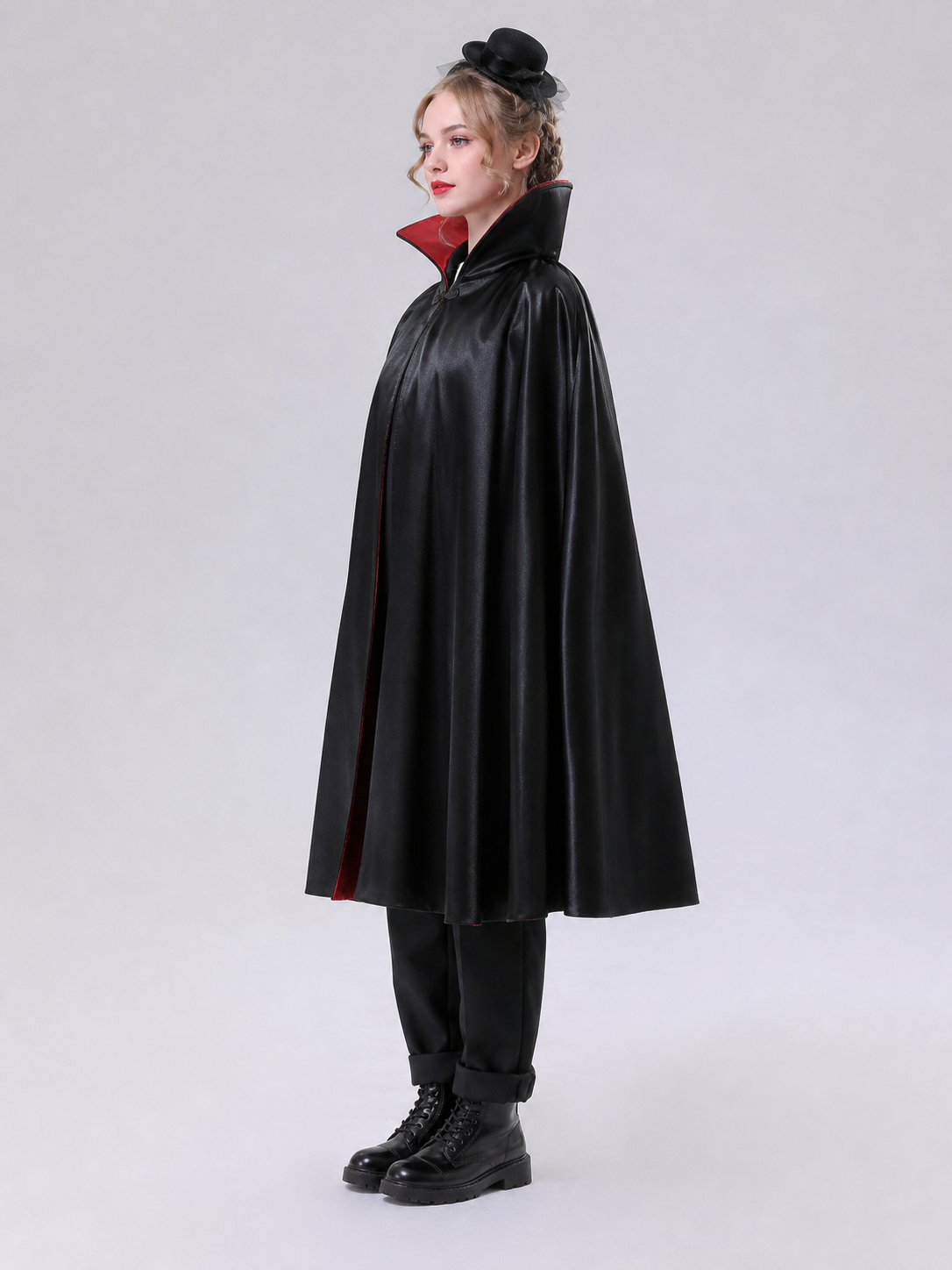 The long black cape is designed to create a vampire look for cosplay, Halloween, and stage performances. The cape is black and features a loose silhouette with long, draping panels and an opening lower edge. The upper section has a hooded o