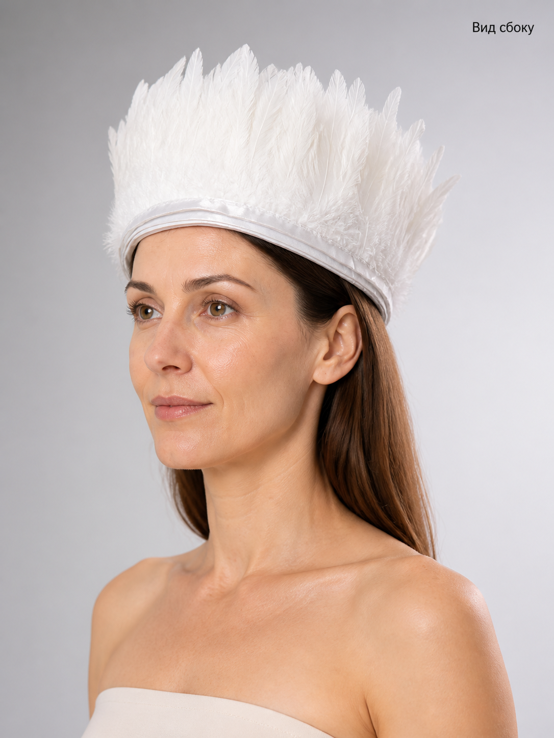 White feather headpiece shown in side view on a model, with layered feathers and a narrow wrapped band