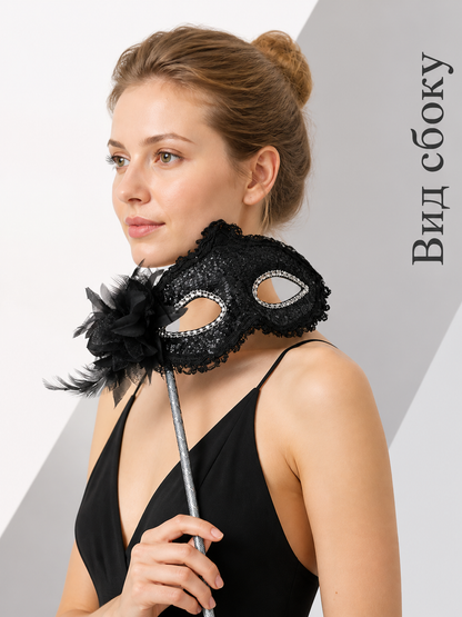 Carnival mask with black lace and feathers on a stick side view