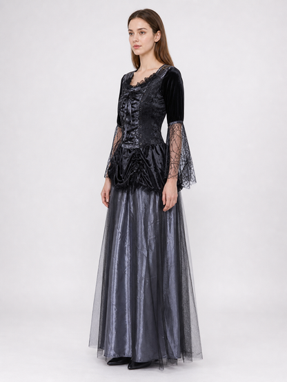 Gothic-style witch costume dress with hat for themed events. The design is mainly black and dark gray, with patterned textured fabric and sheer black accents. The look is centered on a long dress with a fitted lace-up corset, a ruffled neck