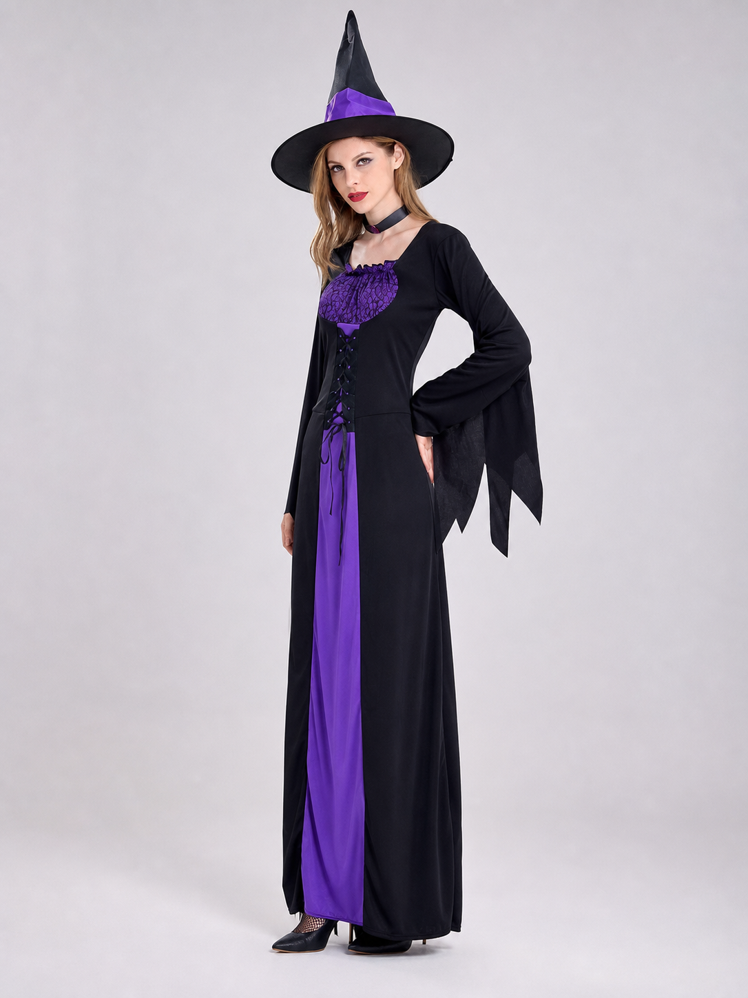 Cosplay costume designed as a long black and purple wizard-themed dress. The set includes a dress, a pointed wide-brimmed hat, and a collar. The design features long sleeves with flared cuffs, a fitted upper section, and a lace-up front. Th