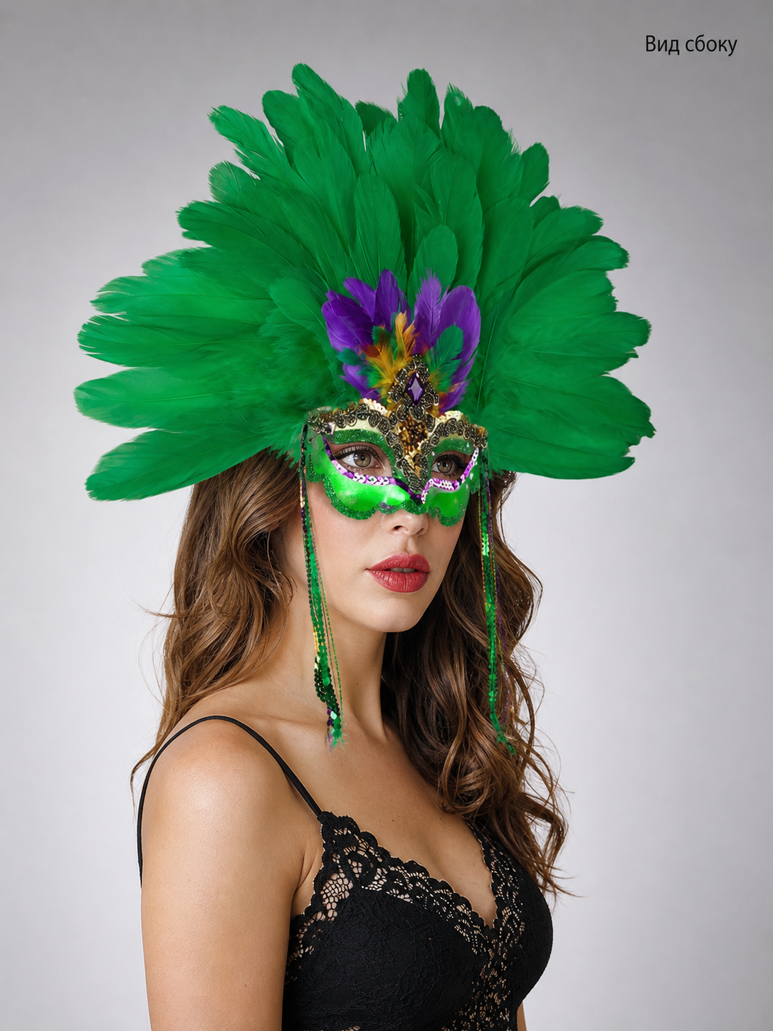 Back view of a woman wearing the green feather mask, showing the feather arrangement, headband area, and long green side strands