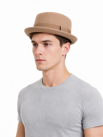 Caramel-colored fedora hat suitable for everyday outfits, outdoor walks, themed events, and costume styling. The design features a classic fedora silhouette: a structured crown with a rounded top, a distinctive front indentation, and a wide