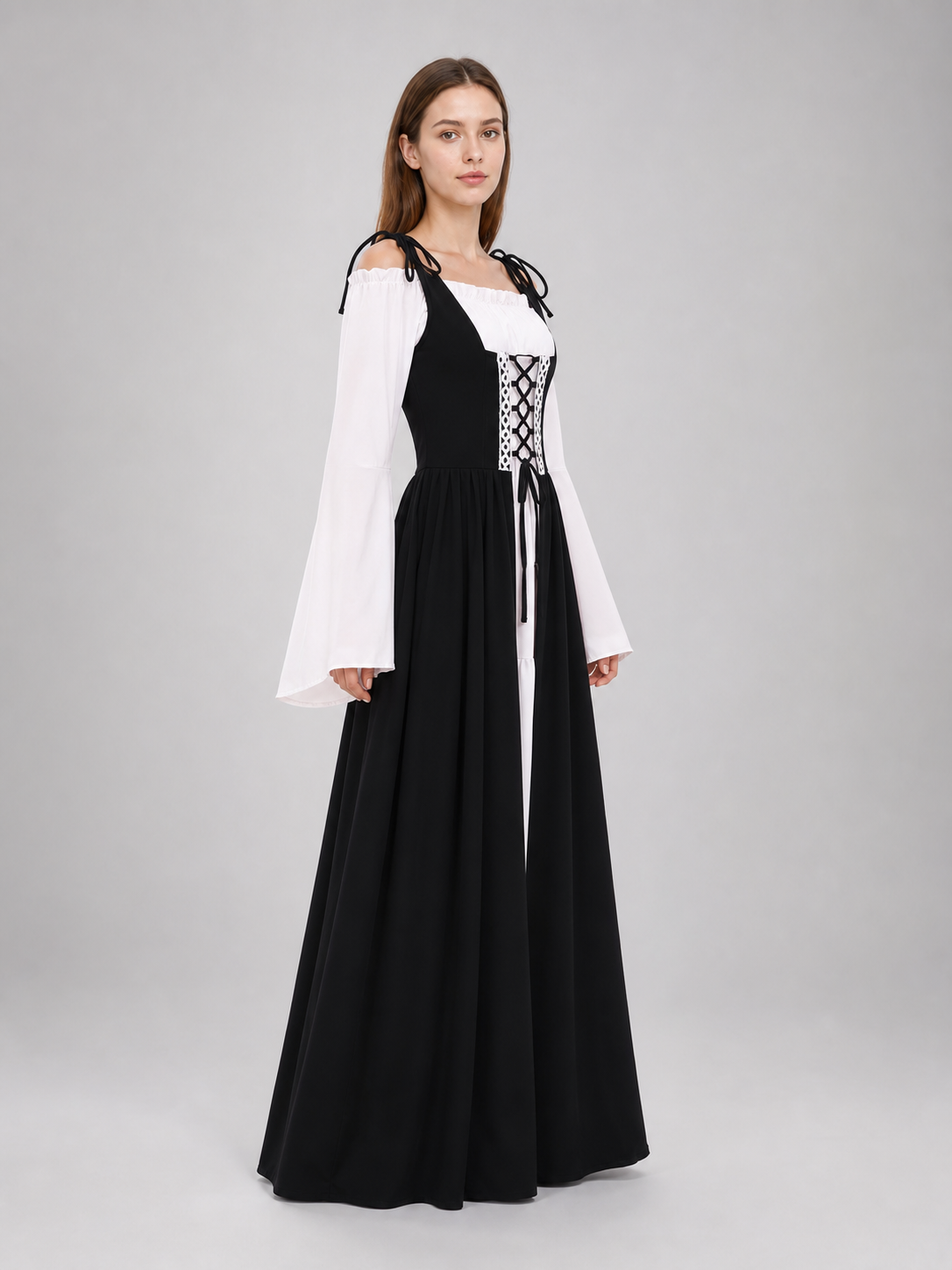 The dress is designed in a vintage medieval style and features characteristic elements of Renaissance-era clothing. The main part of the design is black, while the white details create a striking contrast. The fitted black bodice features a