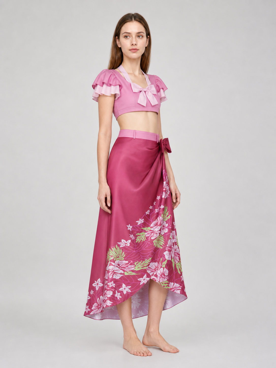 This cosplay set is designed as a short-sleeve crop top and a long skirt. It includes a top, a half-skirt, and decorative bows. There is a bow on the chest of the top, and another bow is placed on the side of the skirt waist. The top has an