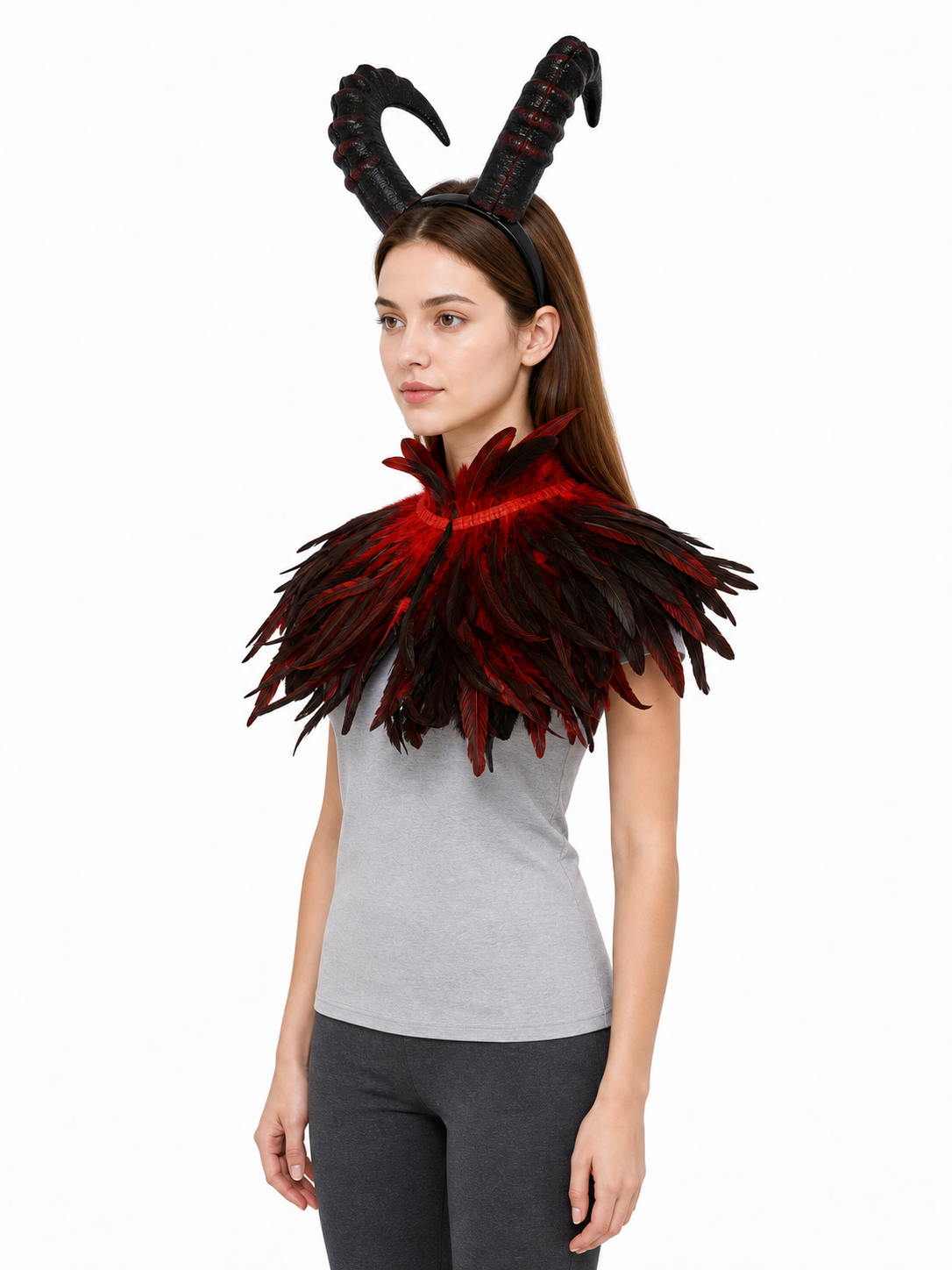 Three-quarter view of a model wearing the black and red horned headpiece with a layered feather collar
