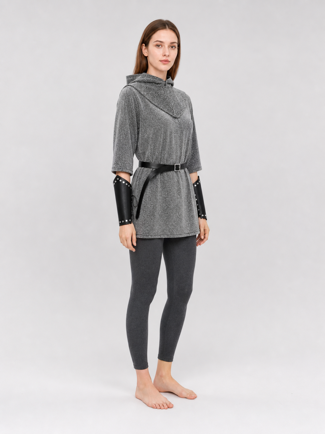 The set is designed in a medieval style and is suitable for creating a cosplay or stage-performance look. It includes a gray long top with a hood, a headpiece in the form of a gray hood, black bracers, and a black belt with a square buckle 