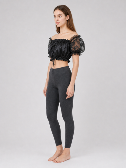 The blouse is black: the main body is made of opaque, smooth fabric