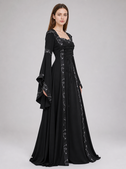 The dress is designed in a gothic style with elements of Victorian aesthetics. The model features a flared silhouette, a square neckline, and long sleeves with flared cuffs. The bodice is decorated with gathers that emphasize the garment’s 