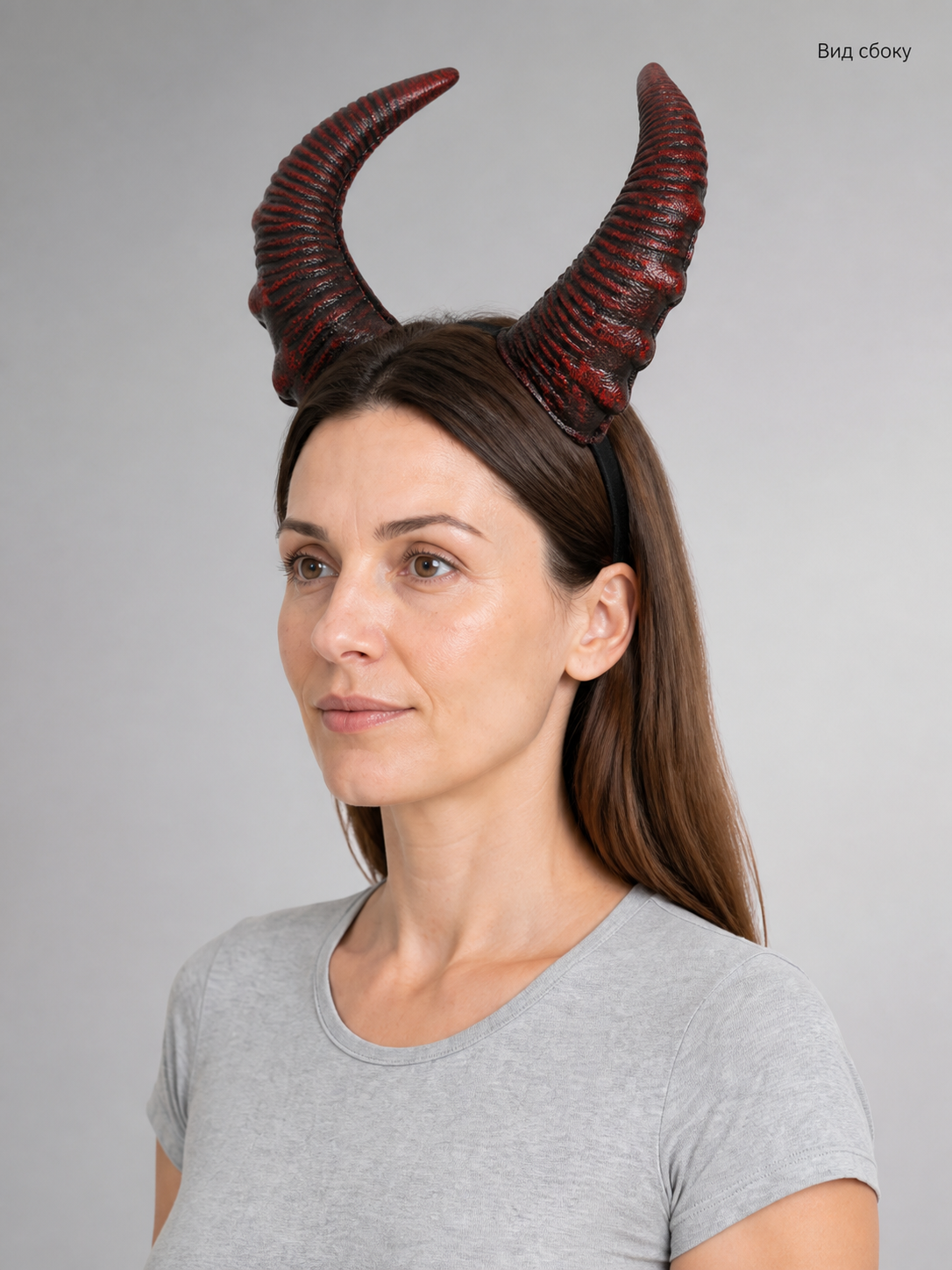 Information card showing a side view of the red and black textured horn headband worn by a model
