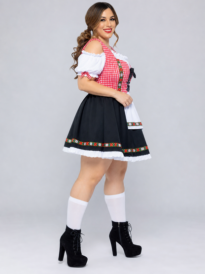 Historical national costume presented as a dress-like outfit with a decorative apron and distinctive details. The design combines white, red, and black colors: the top features a red-and-white checkered pattern, while the lower part is desi