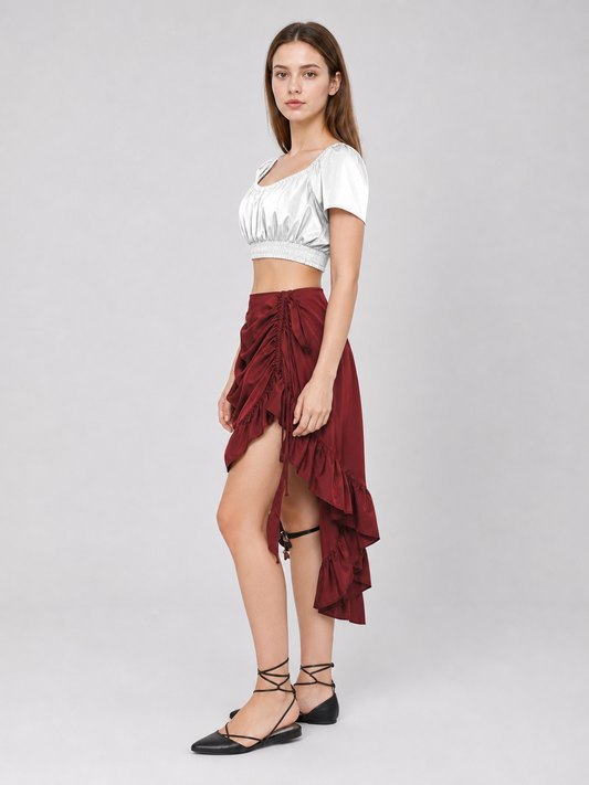 Burgundy asymmetrical skirt with gathered draping and drawstring details, shown full-body on a model with a high-low hem