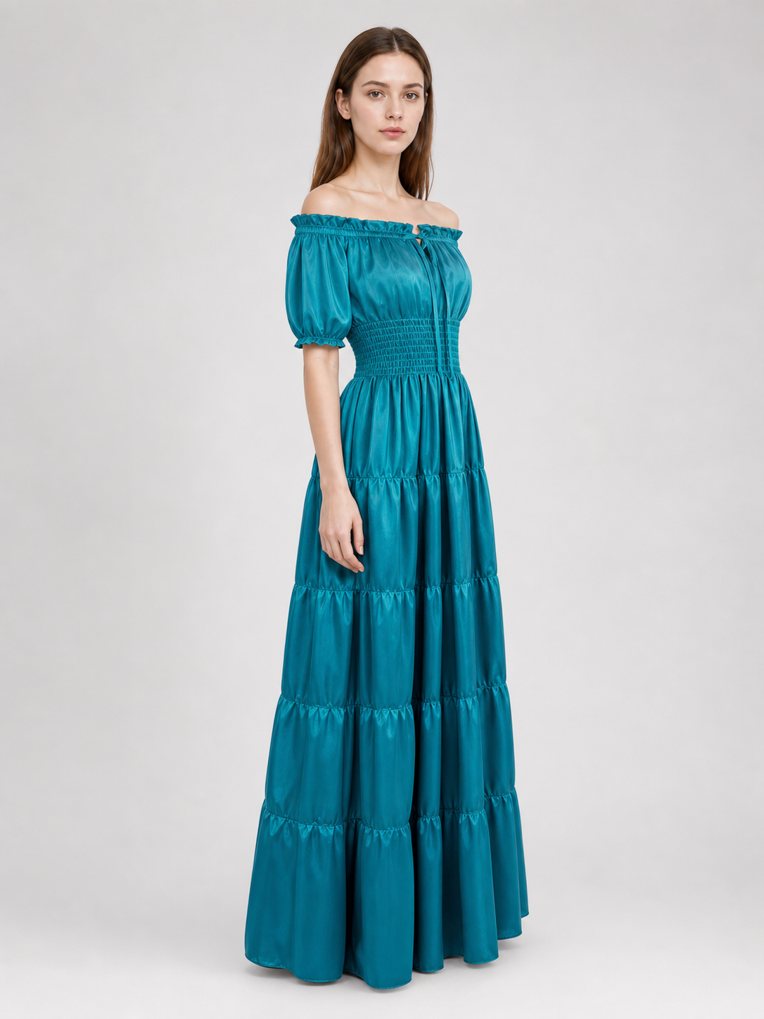 Romantic medieval-style maxi dress. This style features an off-the-shoulder neckline with a gathered elastic edge, short puff sleeves, and a fitted waist with gathering. The long floor-length skirt is made up of several tiers with soft gath