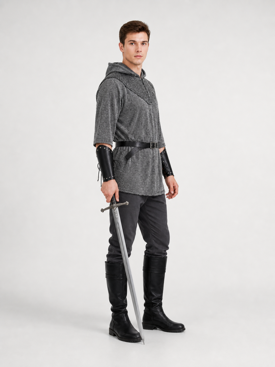 The costume is designed in the style of a medieval knight and is suitable for cosplay and stage performances. The set includes a gray hooded top with a layered front design, black pants, a belt, bracers, and greaves. The gray-and-black colo