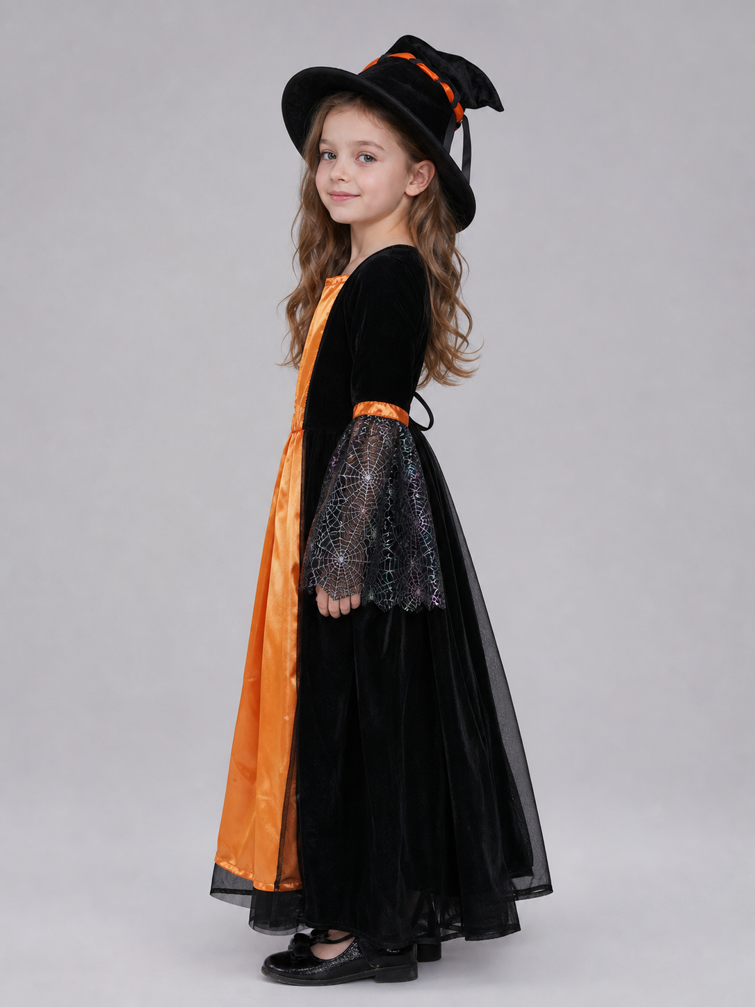 Witch-style costume set featuring a long black dress with long sleeves, a wide flared bottom, and a black pointed hat. The design uses orange, silver, and black colors. The center front of the dress features an orange decorative element, an