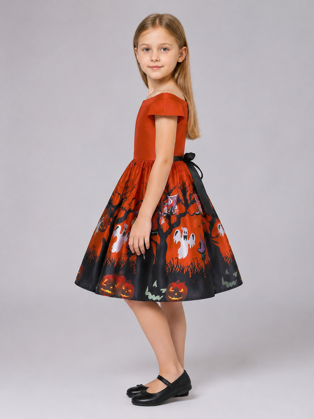 Orange children's dress with a Halloween print side view