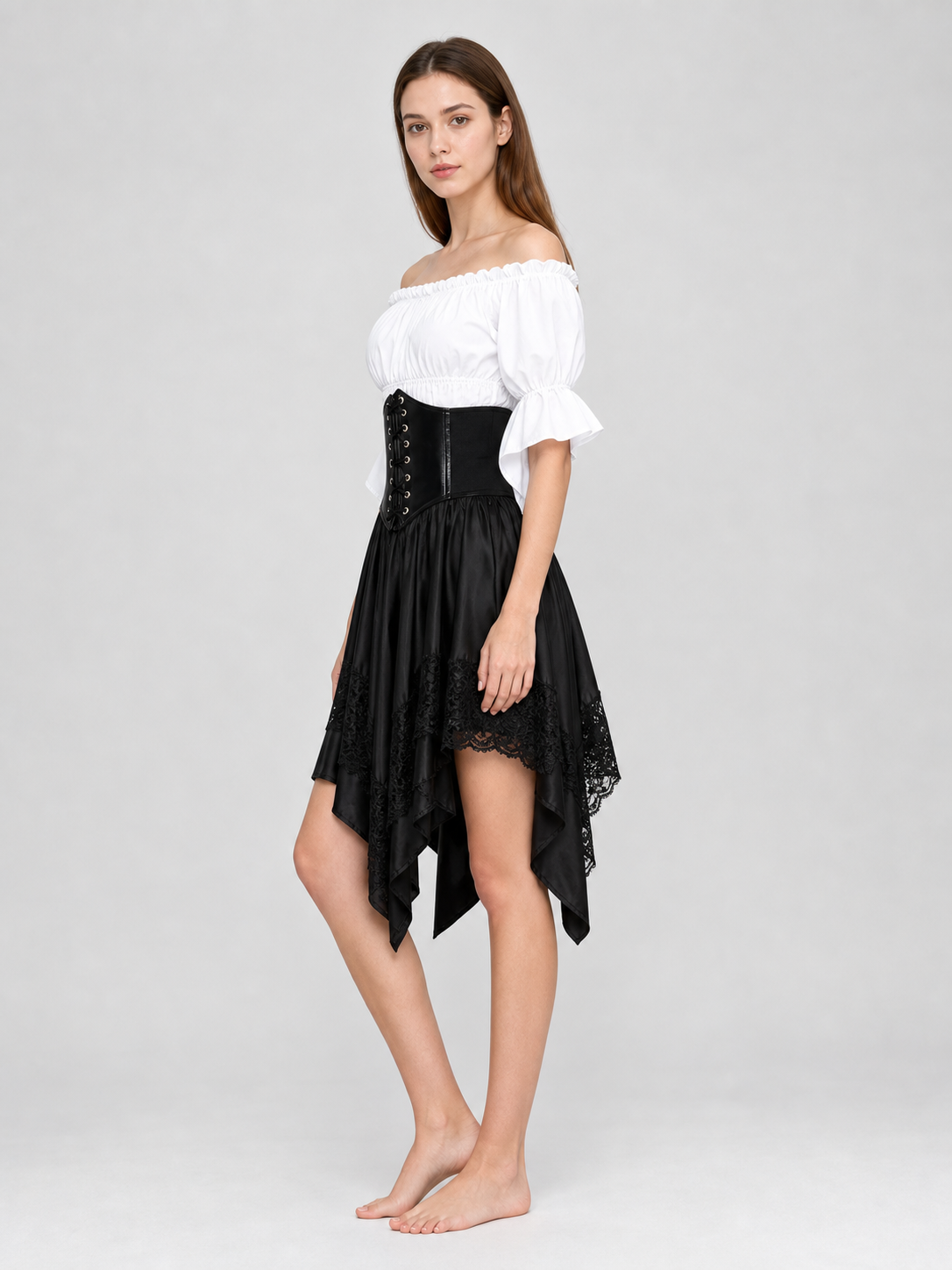 The set is designed in a theatrical pirate style and consists of a white cropped off-the-shoulder top with voluminous puff sleeves, a black corset with front lacing and metal eyelets, and a black asymmetrical skirt with elongated pointed pa