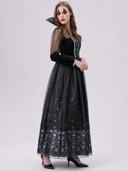Black gothic-style dress with silver-white decorative skull motifs. The design features a long silhouette with sheer mesh sleeves and an accent neckline with a pointed shape. Silver decorative trim is placed across the chest, complementing 