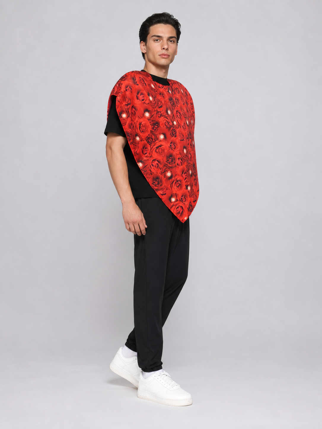 Bright heart-shaped costume with a floral print. A voluminous silhouette with a pointed lower edge and wide short sleeves that extend from the sides of the garment. The surface is decorated with an allover floral pattern reminiscent of rose