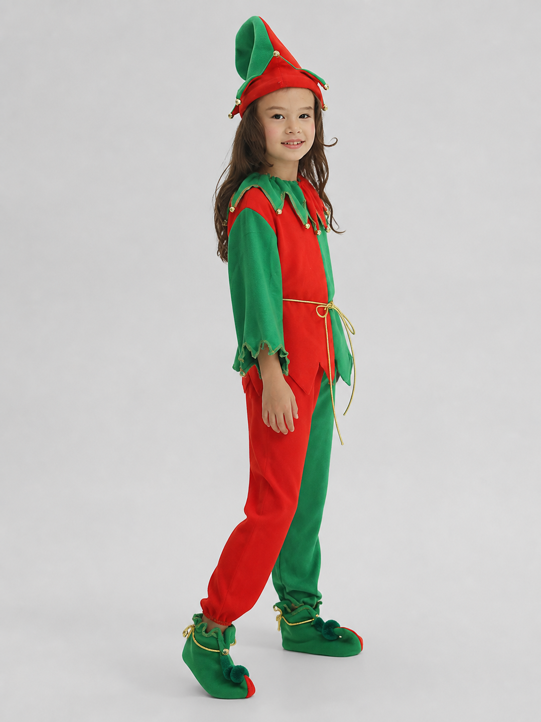 Children's Christmas elf costume in a festive red-and-green design with gold and yellow trim. The set includes a pointed hat with a curled tip and small dangling decorative elements, a long-sleeve top, pants, a gold tie belt for the waist, 