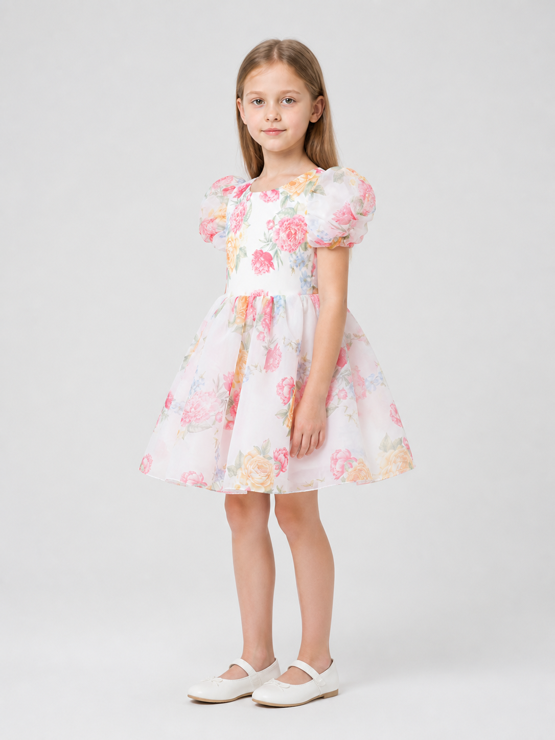 Children's dress with rose print, puff sleeves, and bow side view