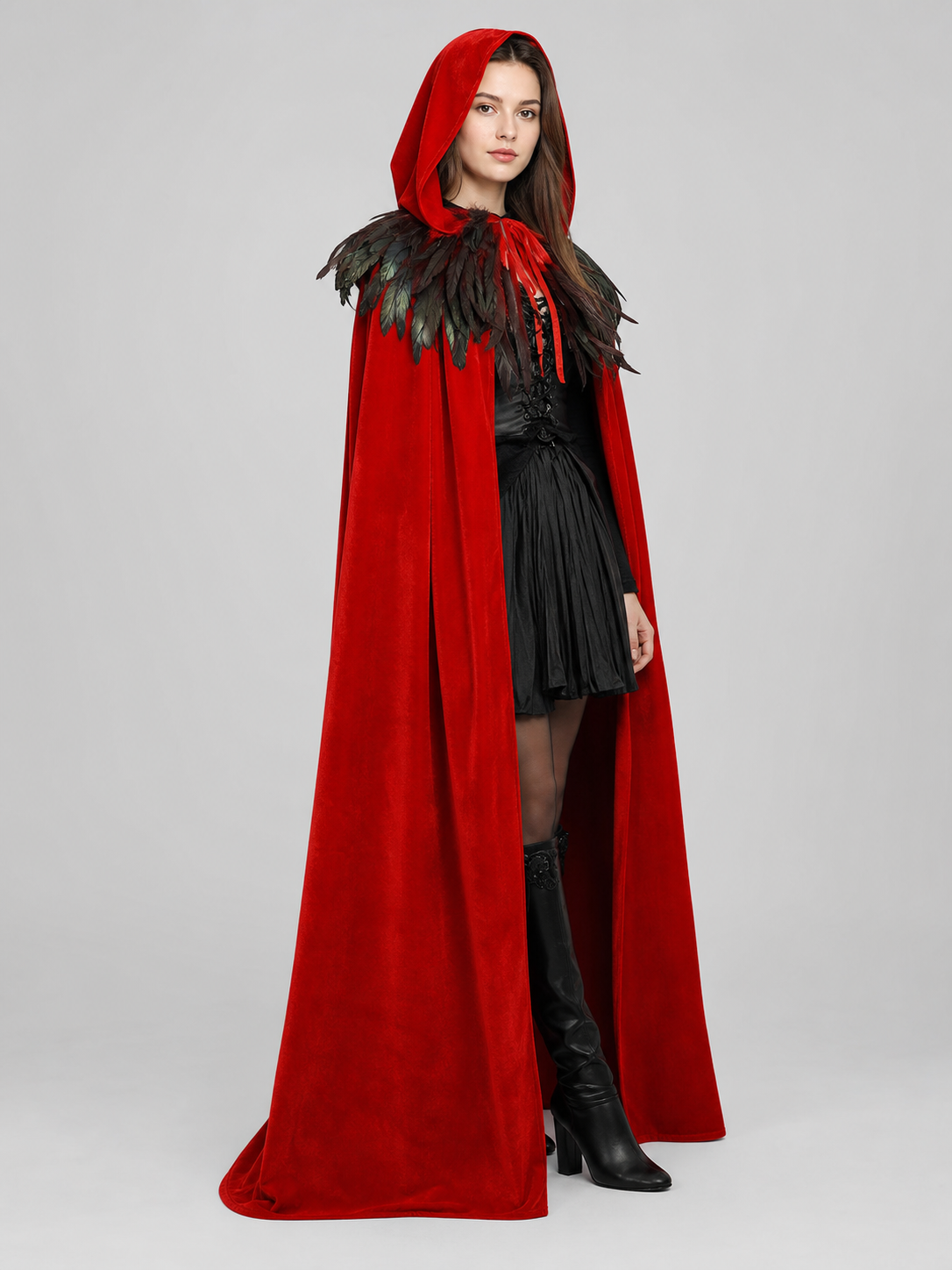 Rear three-quarter view of a red cape with black feather shoulder trim and a red hood