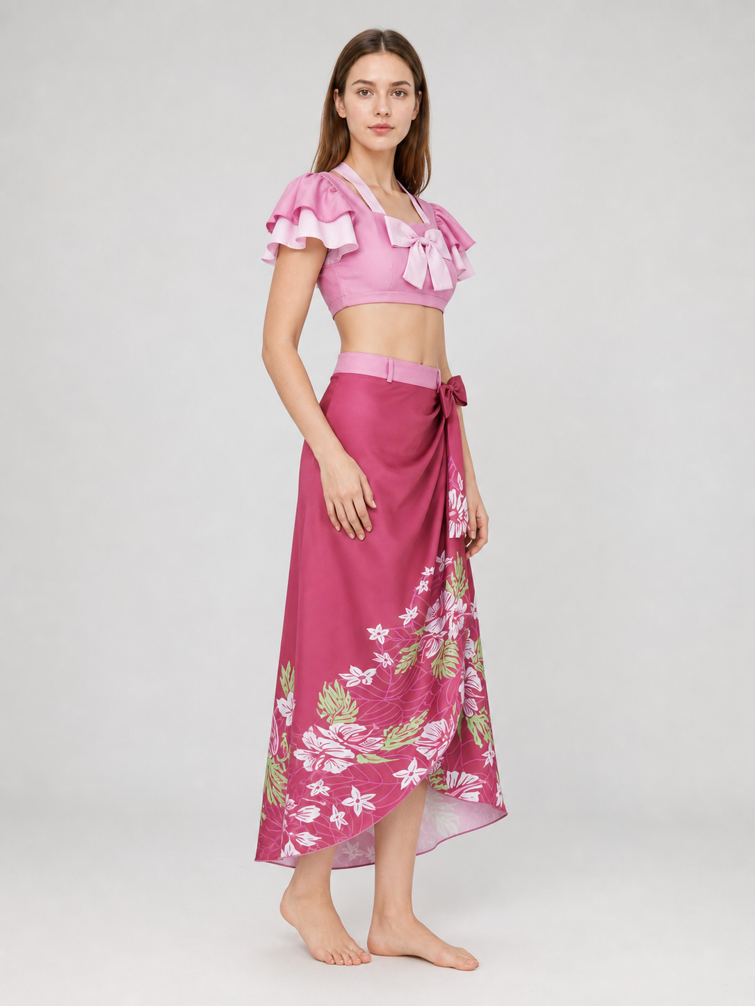 This cosplay set is designed as a short-sleeve crop top and a long skirt. It includes a top, a half-skirt, and decorative bows. There is a bow on the chest of the top, and another bow is placed on the side of the skirt waist. The top has an
