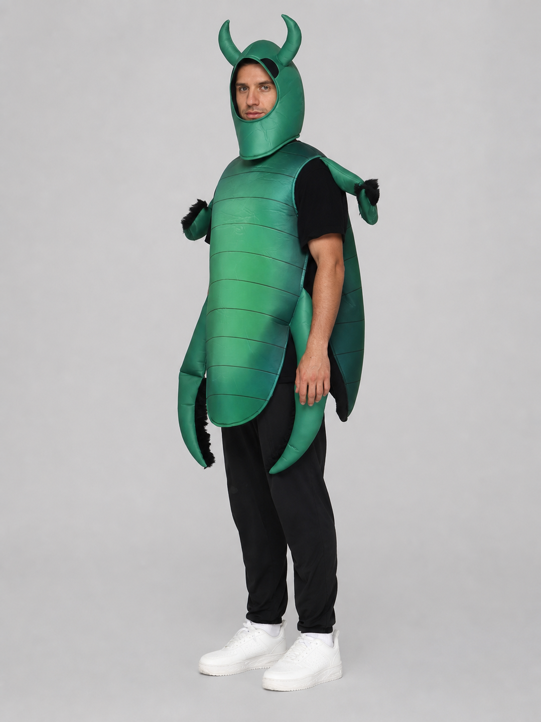 The beetle costume features a full-body insect silhouette with a large segmented green panel on the abdomen. The look is completed by a curved headpiece resembling horns, along with green side and hand elements that imitate insect limbs. Th