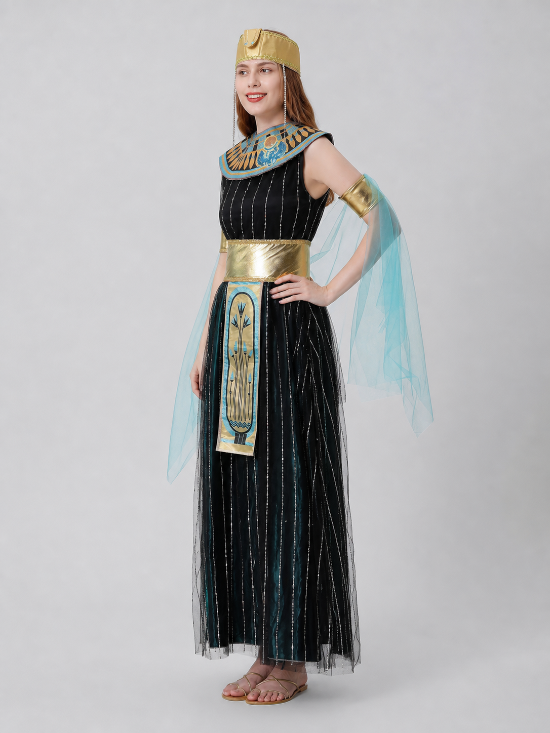 Cleopatra costume designed in an Egyptian-inspired style and decorated in a combination of black, gold, light blue, and blue-green colors. The outfit is centered around a black dress with a skirt and fitted upper section. Vertical sequin st