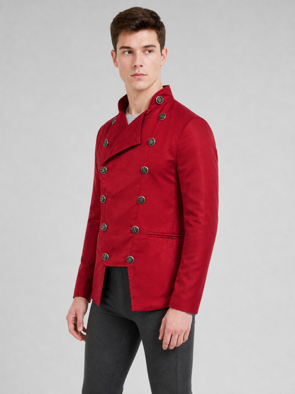 The jacket is presented in a vintage red color and designed in a military style with elements of Gothic aesthetics. The model features a distinctive front construction with a diagonal wrap, giving the garment a bold character. A double row 